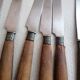 Old table knives and dessert knives, wooden handles, stainless steel blades