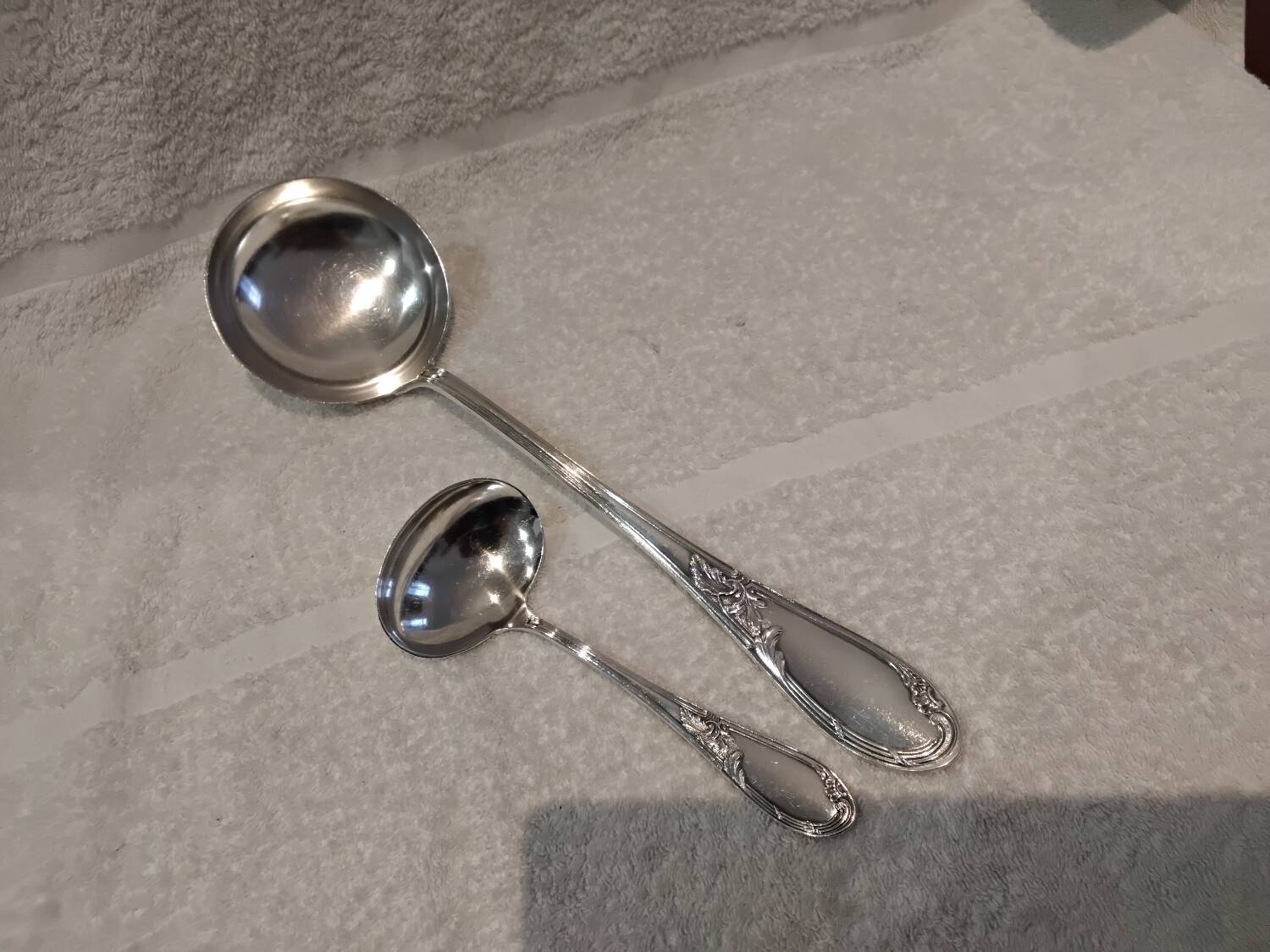 2 Silver-plated soup and sauce ladles with rocaille ribbon decoration
