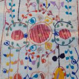 White suzani kilim rug with embroidered colorful patterns