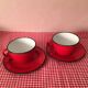 2 cups and their red enamelled saucer