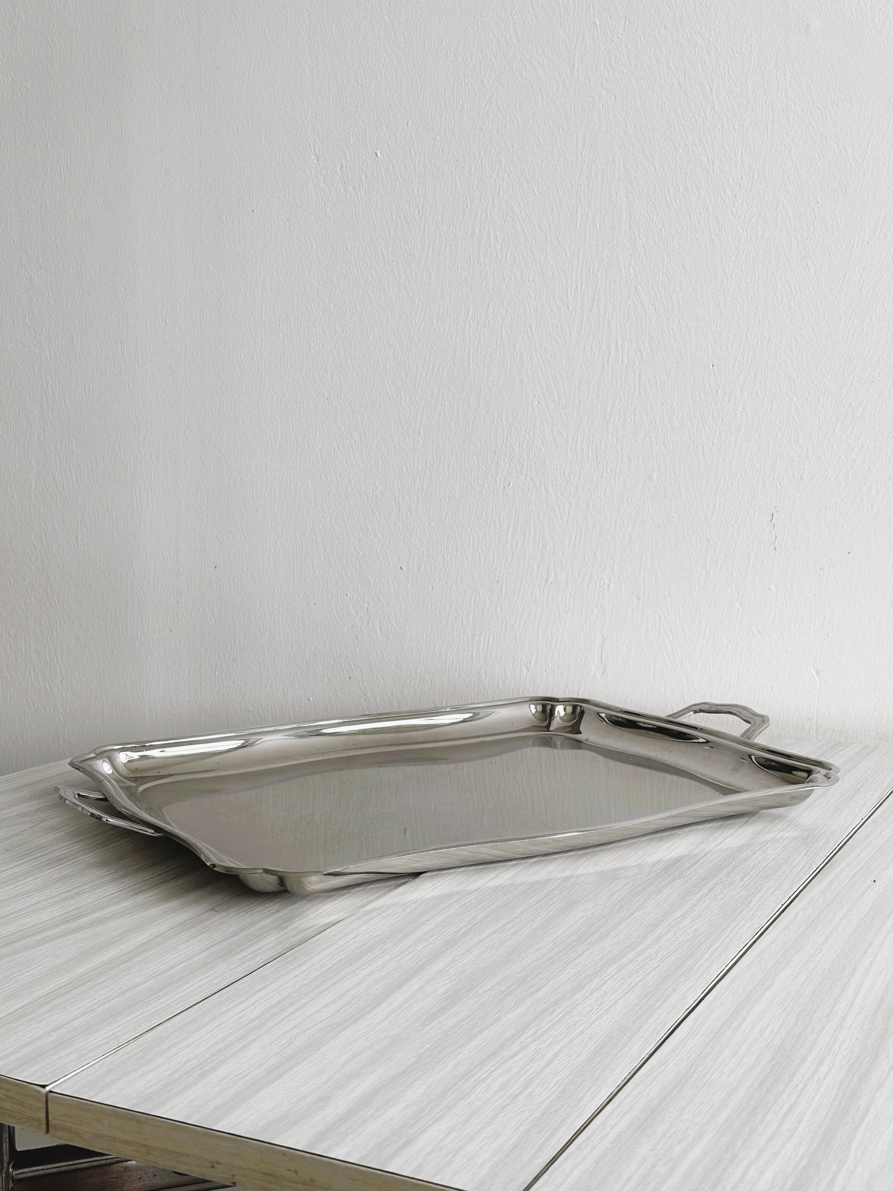 Large shiny metal serving tray