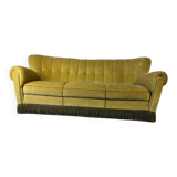 Vintage yellow-green fringed three-seater sofa