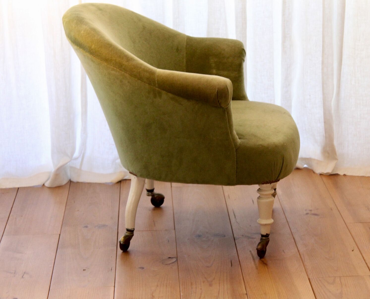 Toad in almond green velvet armchair on castors