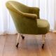 Toad in almond green velvet armchair on castors