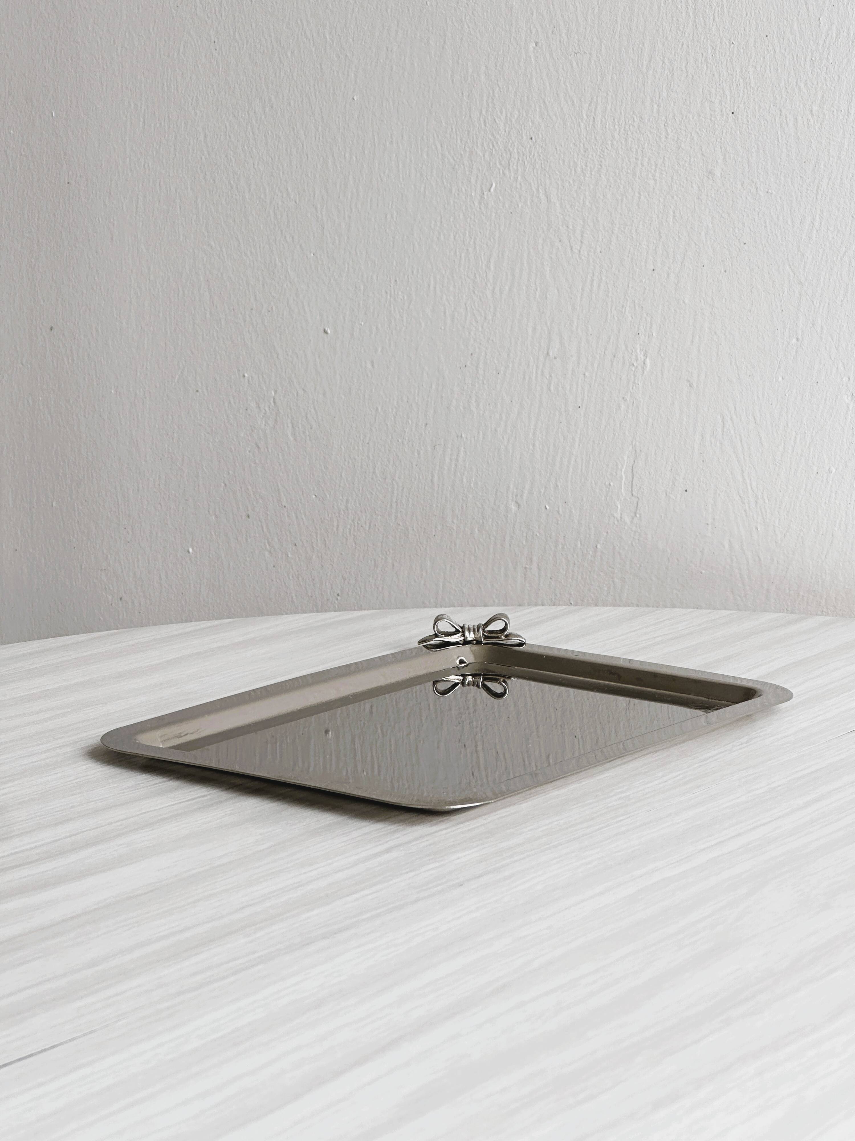 Small vintage metal tray with decorative knot