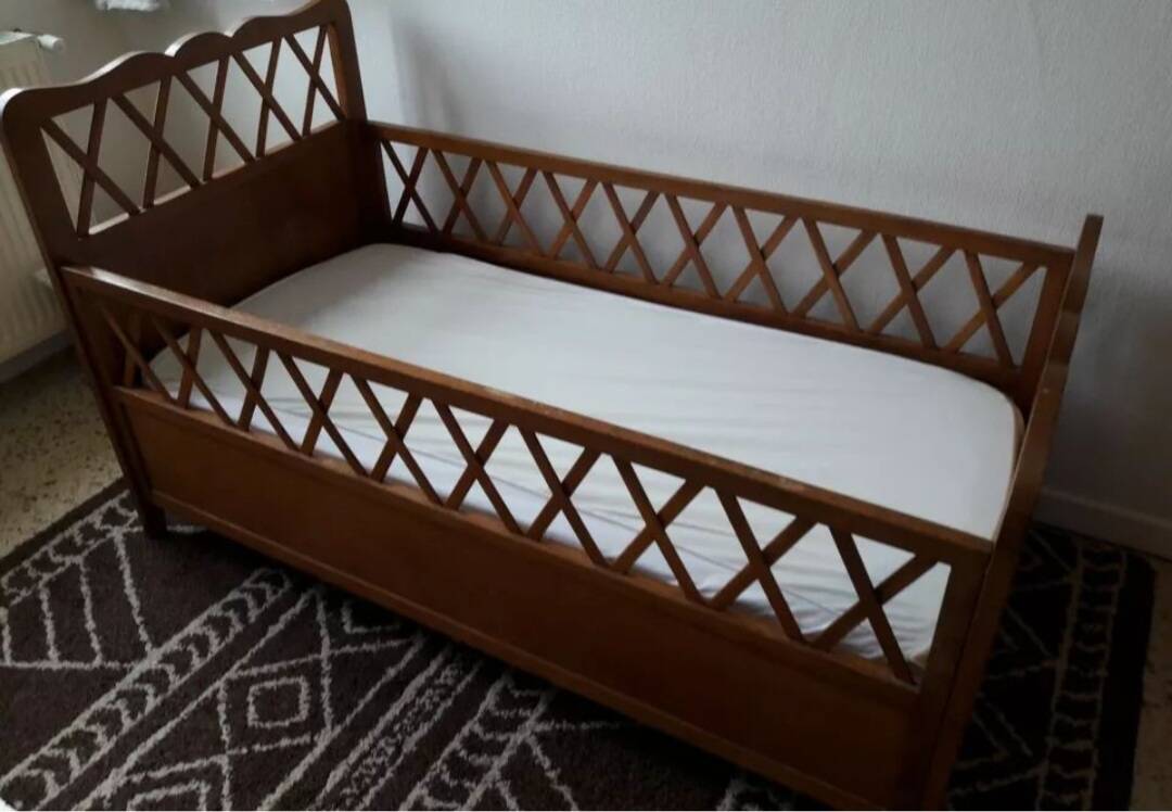Vintage wooden baby cot from the 1960s.