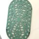 Old oval trivet in green enameled cast iron