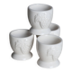Vintage white porcelain egg cups with fruit motif.
