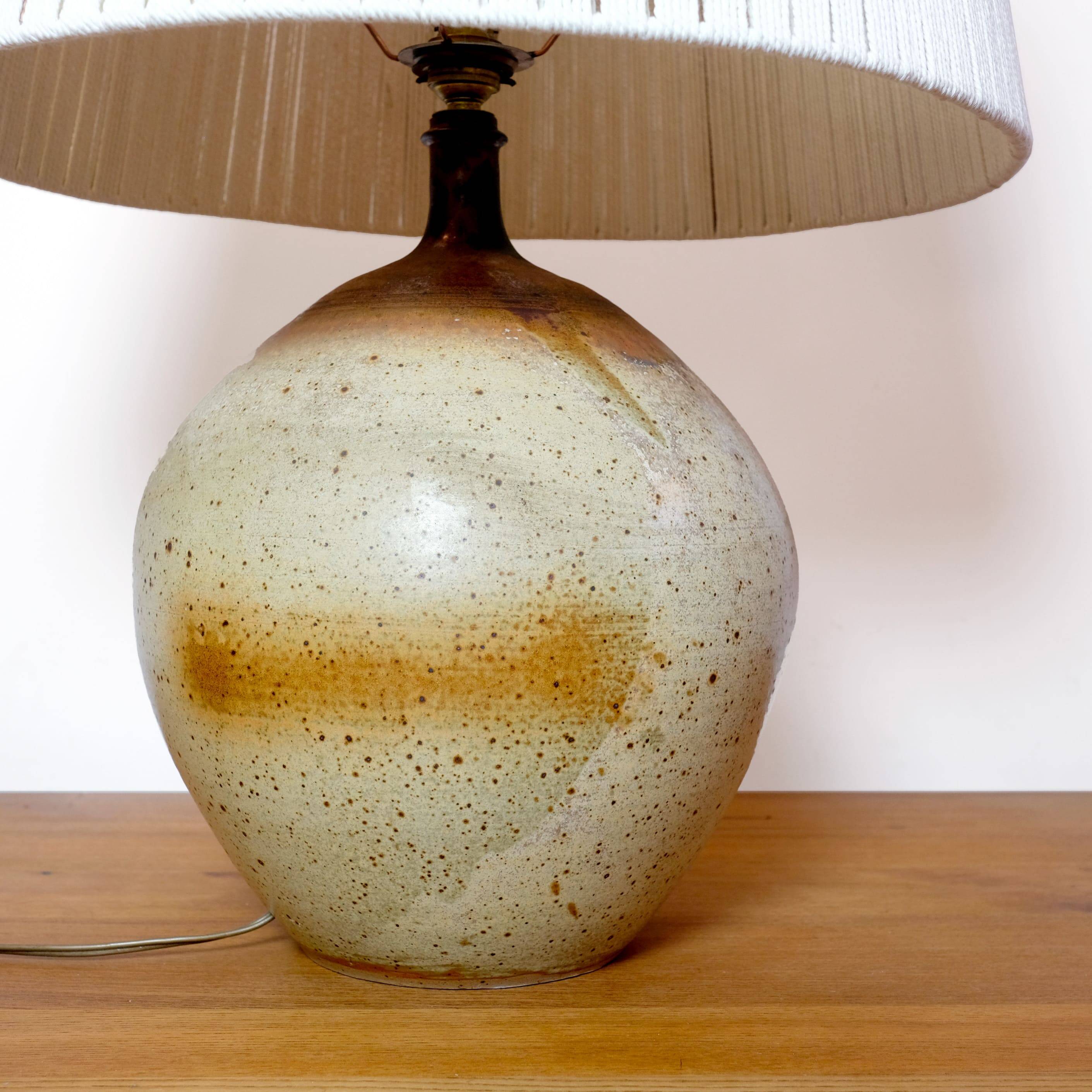 Large stone lamp with a cotton shade.