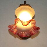 French Art Nouveau wall sconce in bronze with a white and pink glass shade.