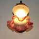 French Art Nouveau wall sconce in bronze with a white and pink glass shade.