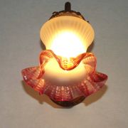French Art Nouveau wall sconce in bronze with a white and pink glass shade.