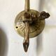 Antique brass wall light with glass shade.