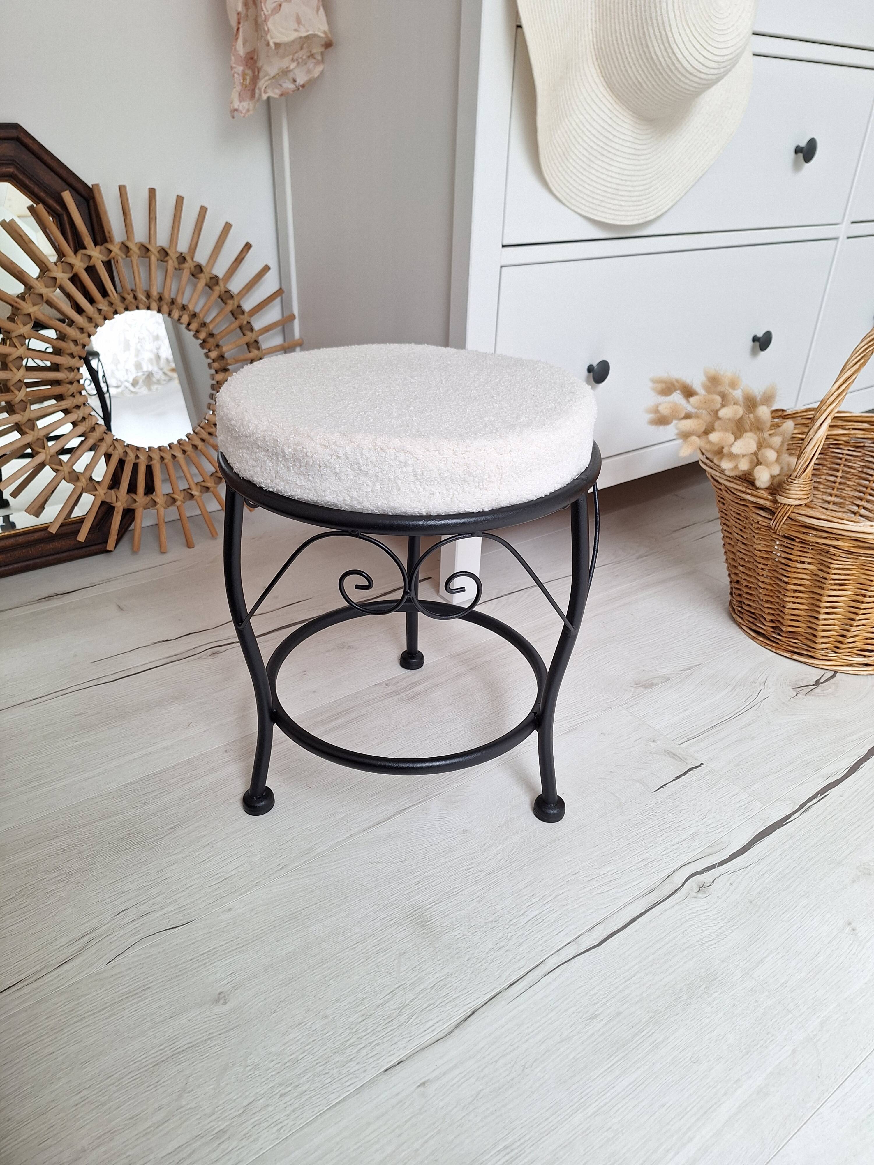 Black iron stool/pouf with its boucle fabric cushion.