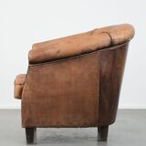 Vintage sheepskin club armchair with character and a beautiful patina