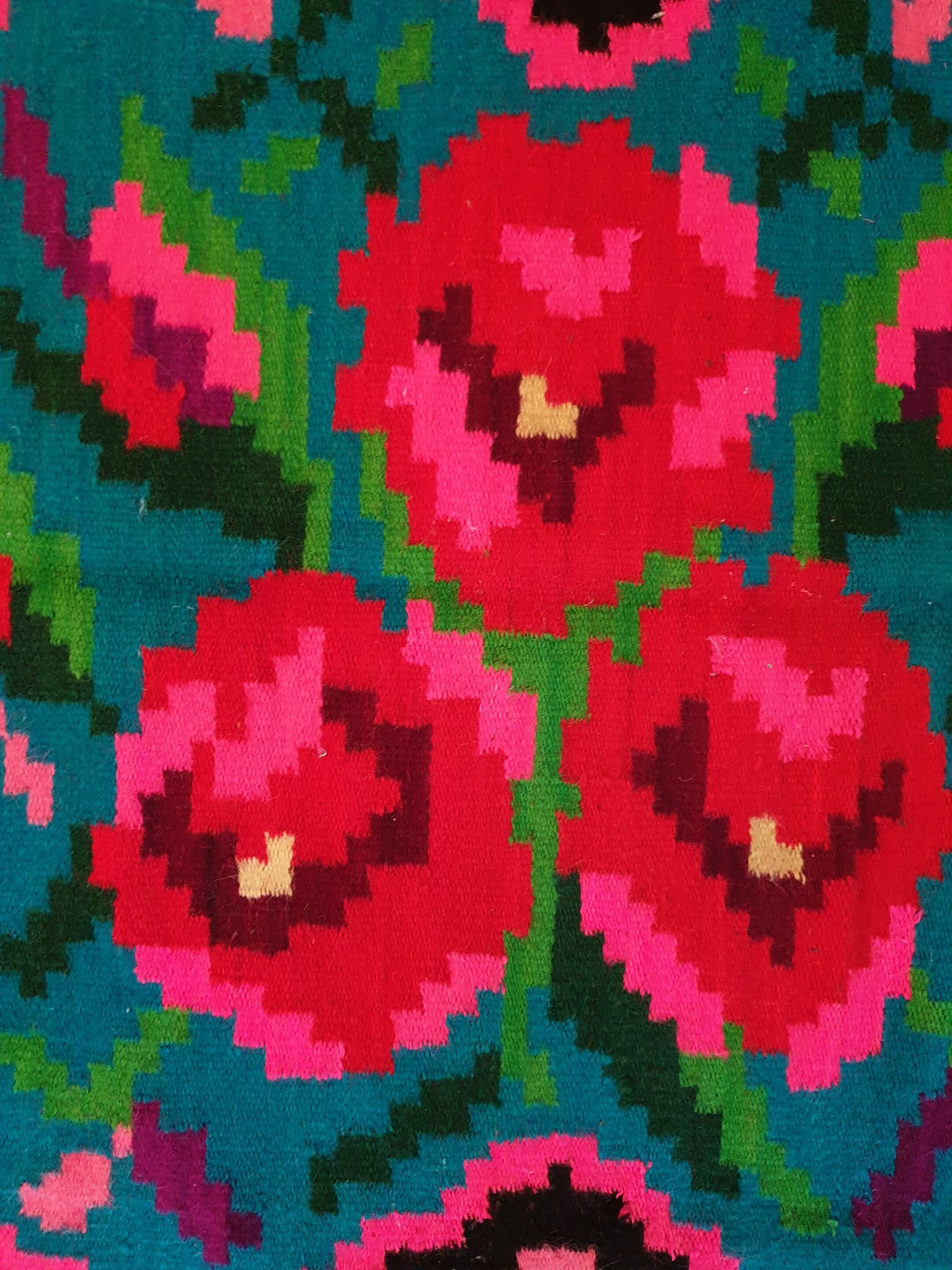 Colorful kilim on black background with floral design