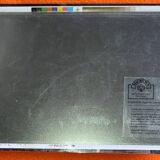 Mercedes flatbed containing drums pulling 1 trailer carrying 1 covered vehicle