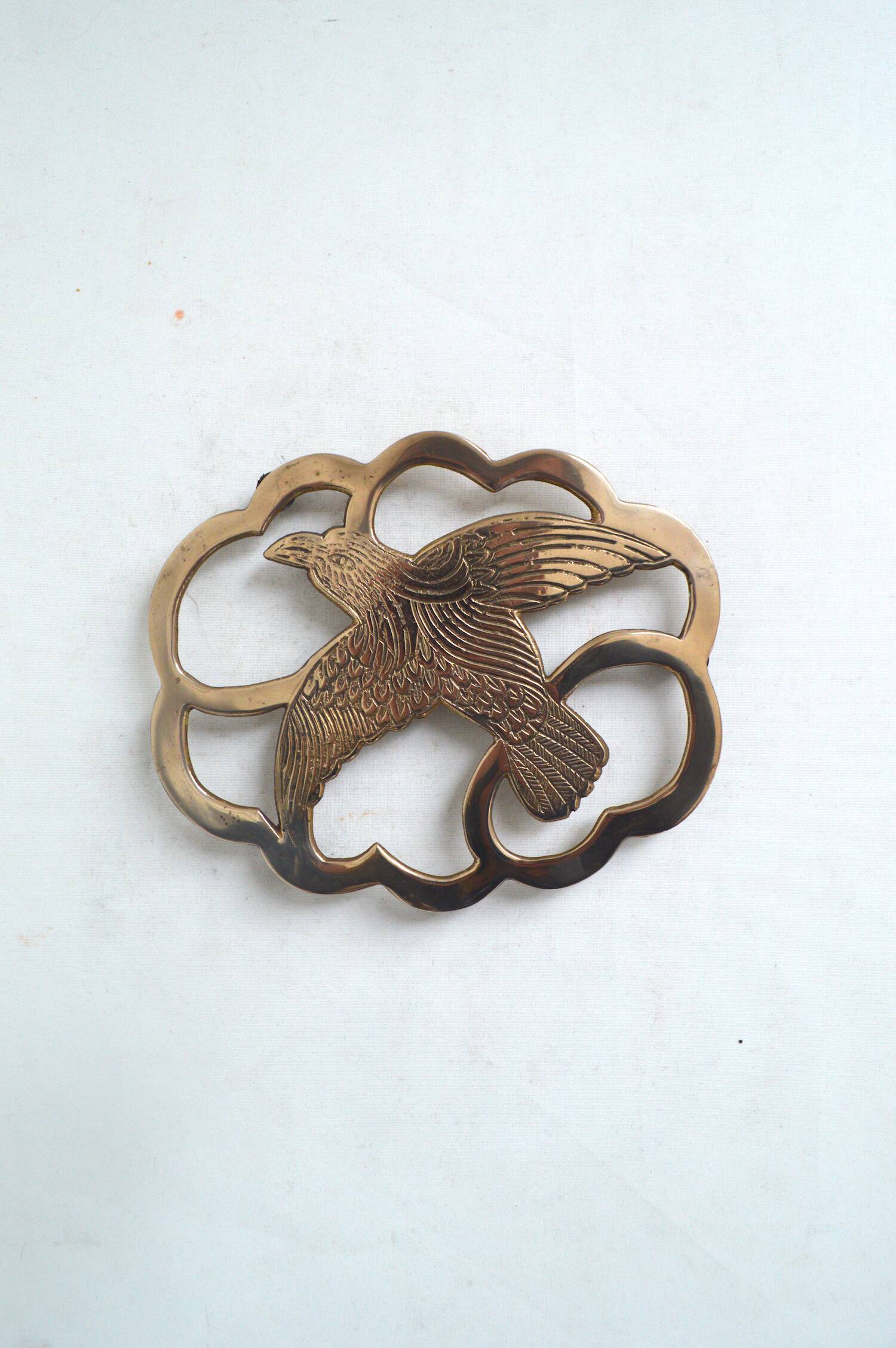 Brass bird trivet