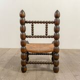 Low chair in beaded wood and straw