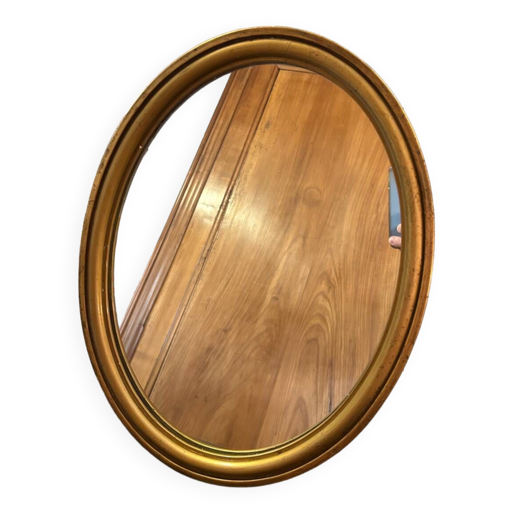 Old oval mirror in gilded wood from the 20th century