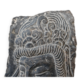 Antique portrait of Buddha hand-carved in stone, 19th century.