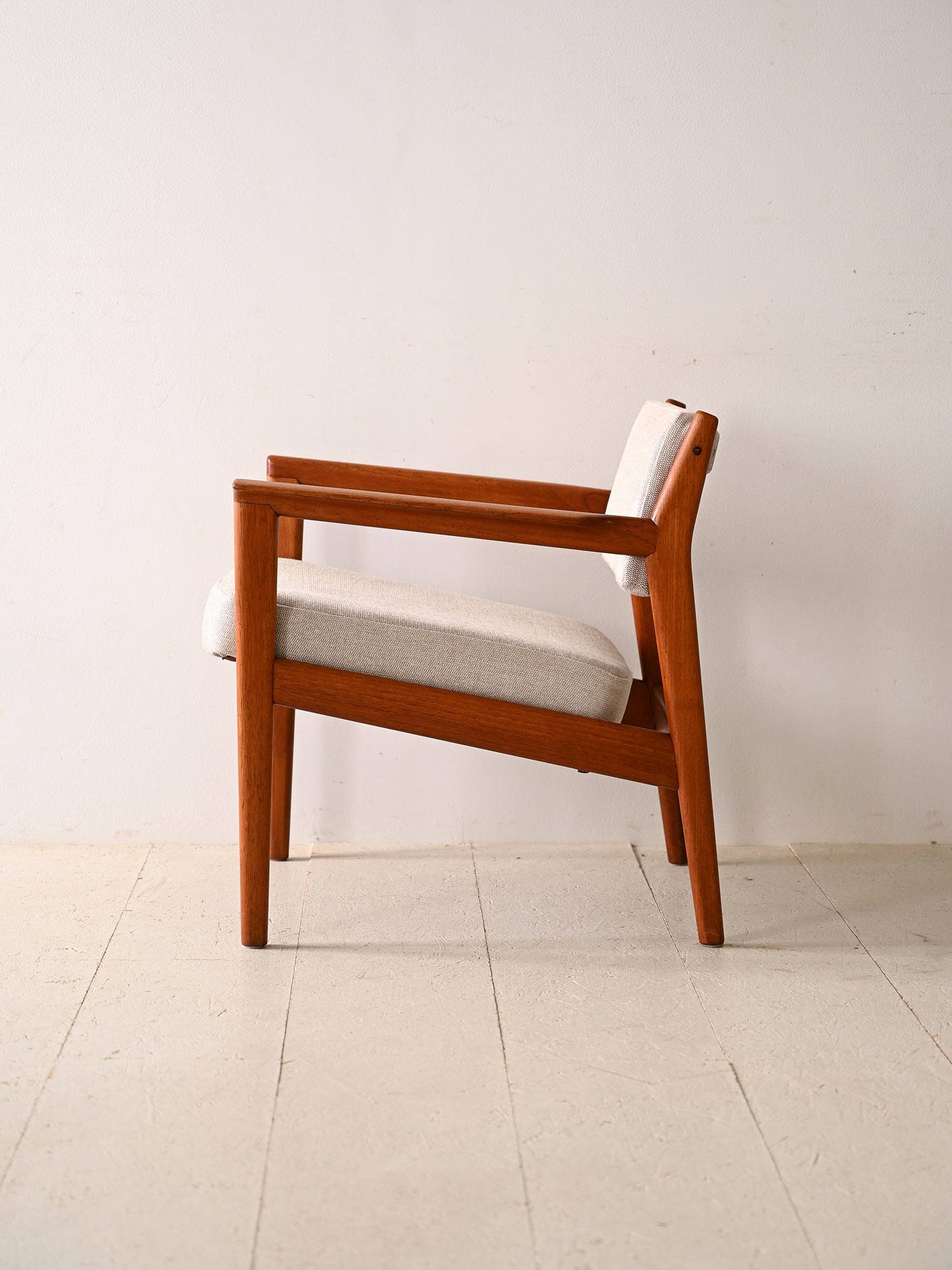 Upholstered armchair with teak frame