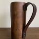 Mountain pitcher in monoxile wood and leather folk art