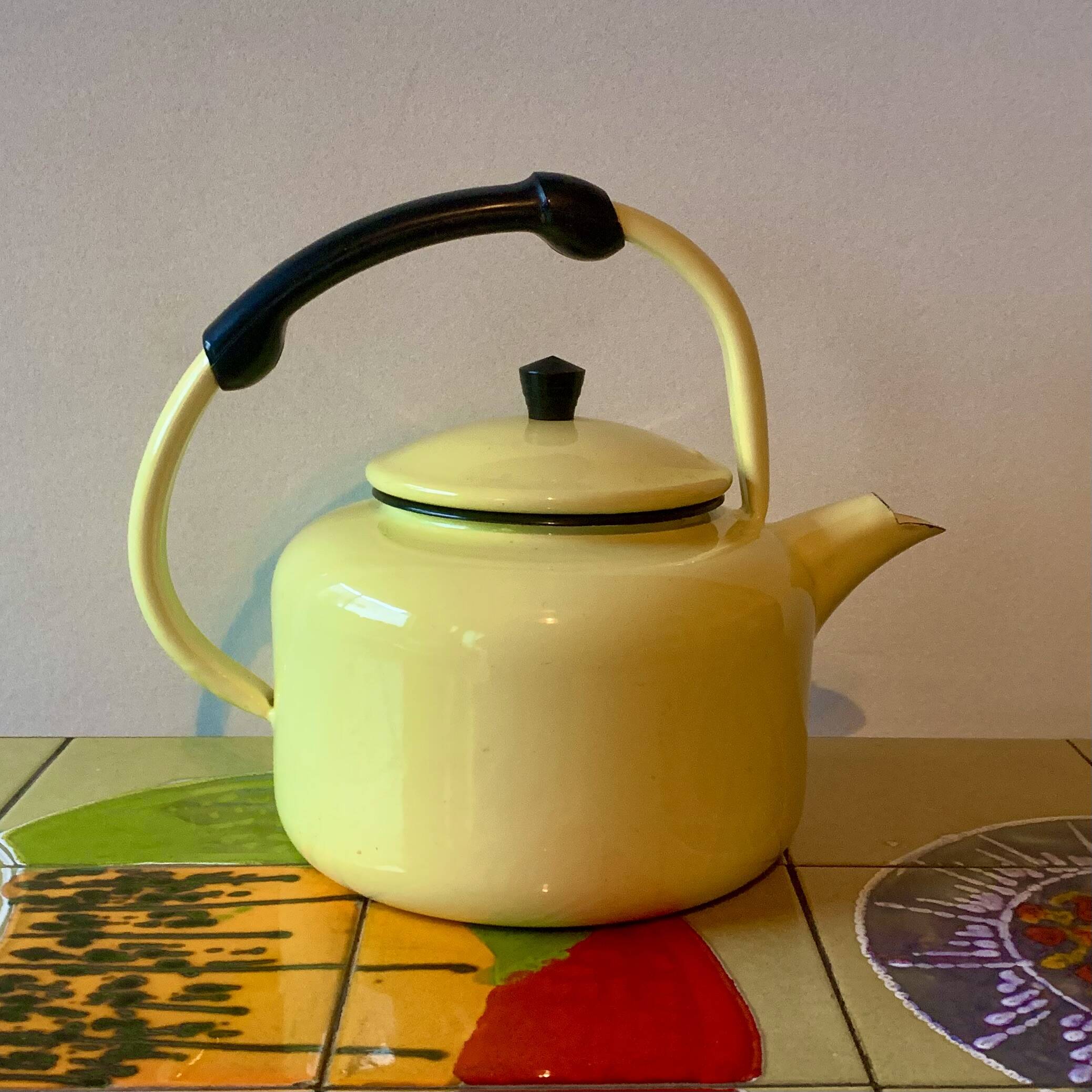 Old kettle in yellow enamelled sheet metal and Bakelite