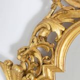 Miroir de style Régence en bois sculpté et doré. Années 1950.