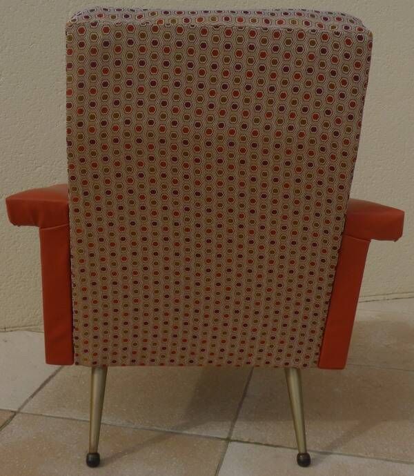 Vintage rockabilly retro armchair in orange faux leather and fabric.