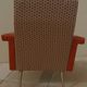 Vintage rockabilly retro armchair in orange faux leather and fabric.