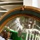 Oval mirror in wood and green and gold stucco, 75 x 42 cm