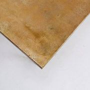 Acid-etched brass coffee table top by Christian Krekels with an agate stone