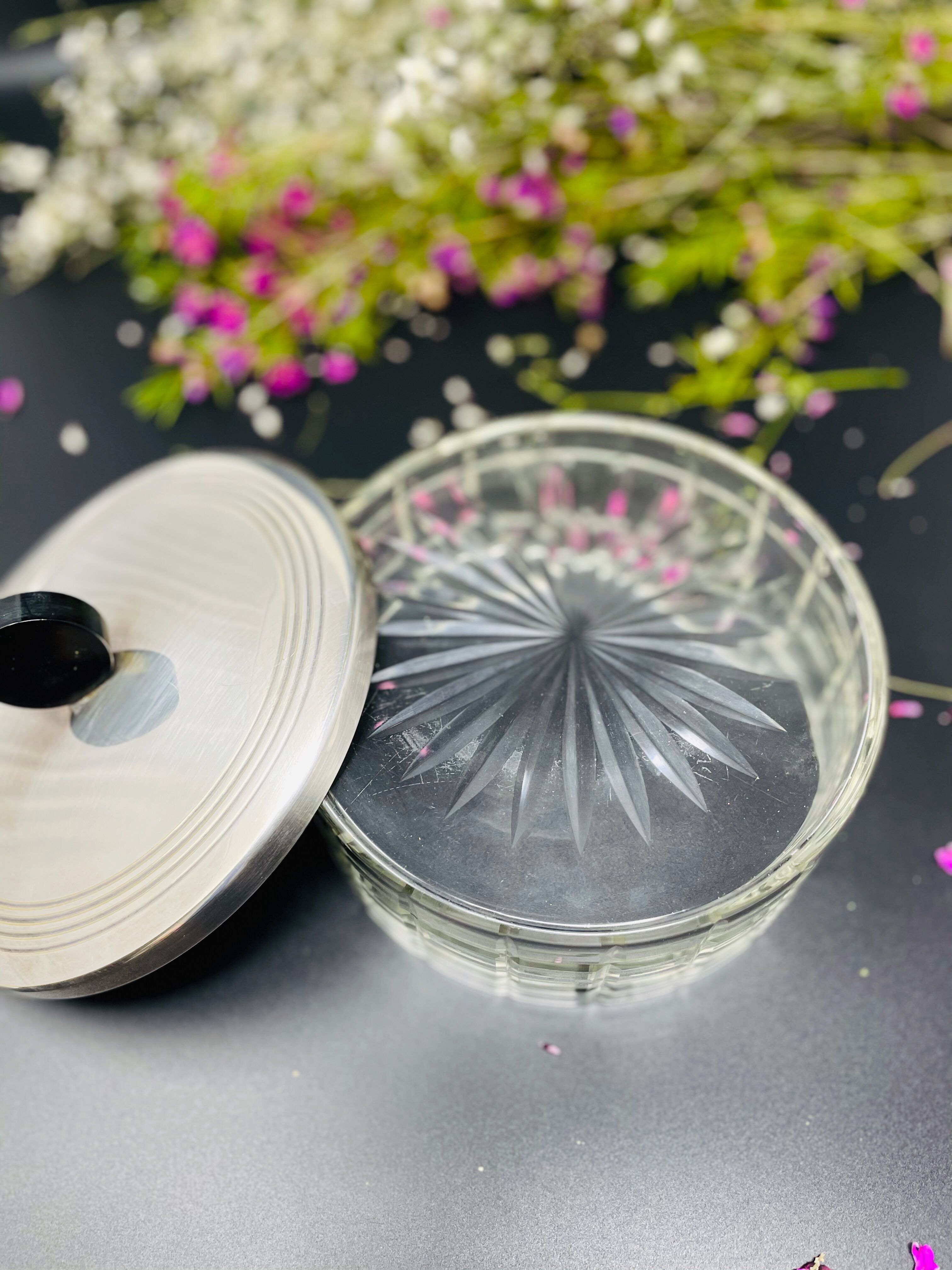 Vintage box made of chiseled glass and covered metal, taken in black Bakelite