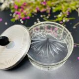 Vintage box made of chiseled glass and covered metal, taken in black Bakelite