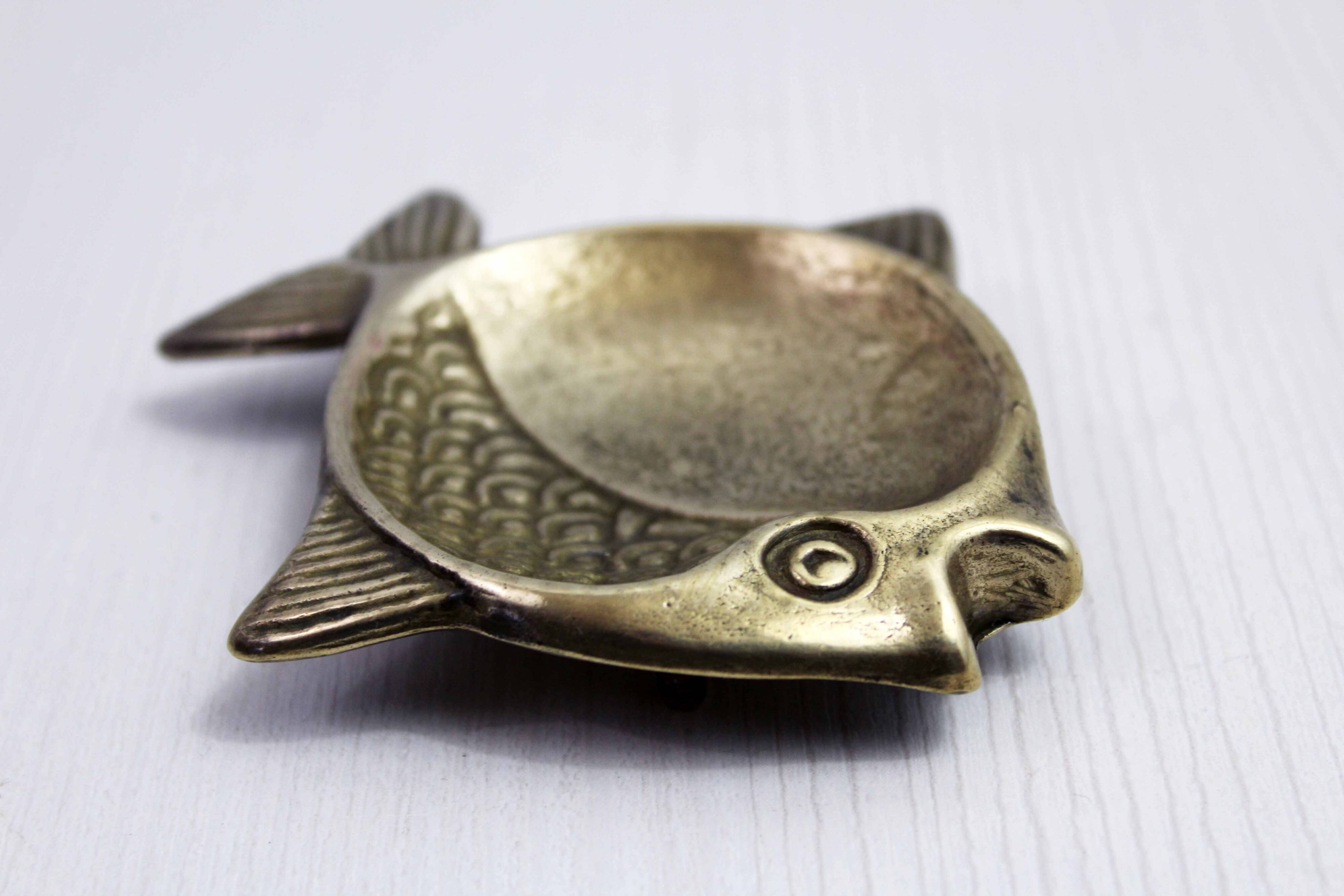 Vintage fish-shaped brass pocket emptier