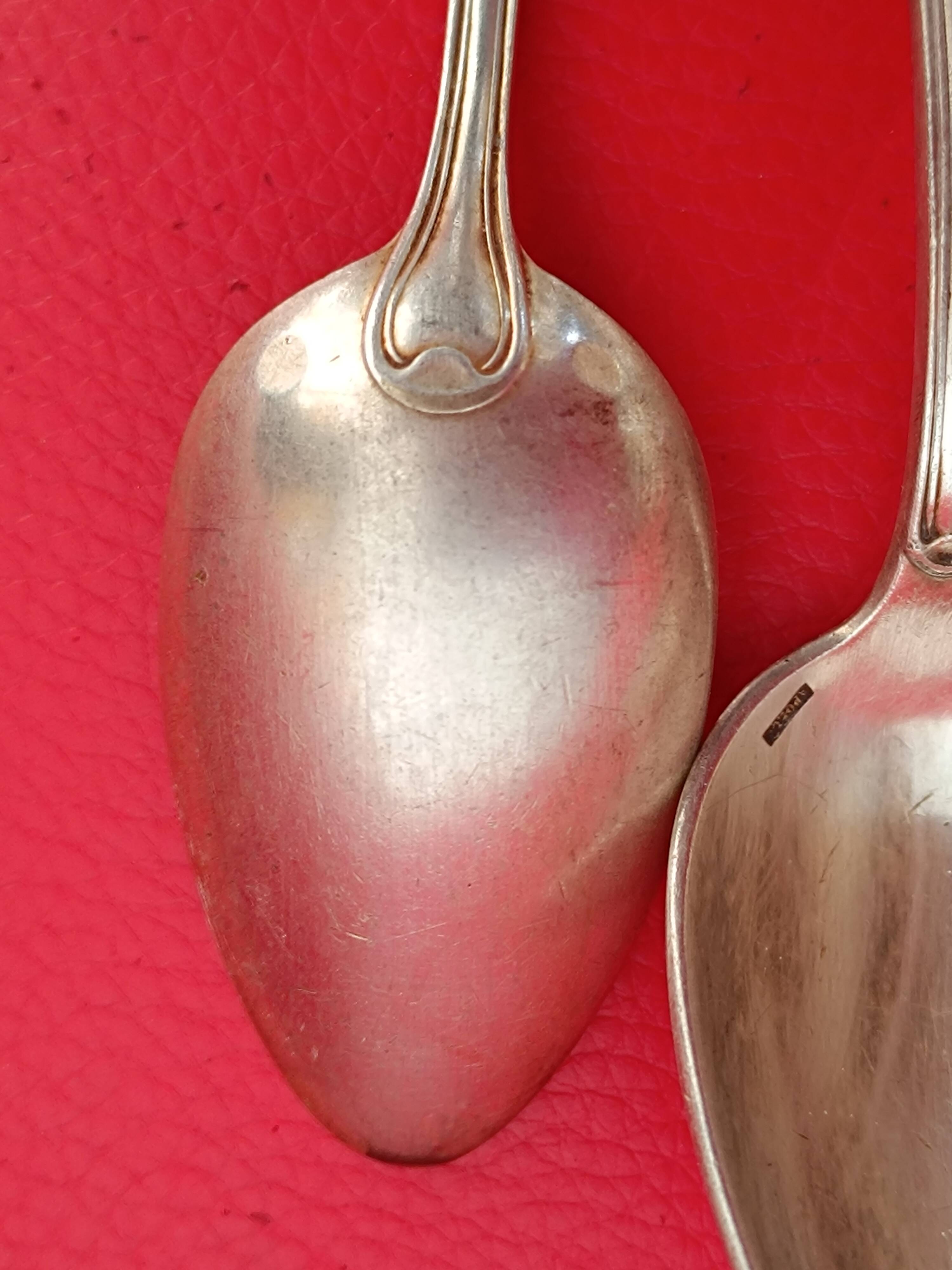 11 Small silver-plated spoons.