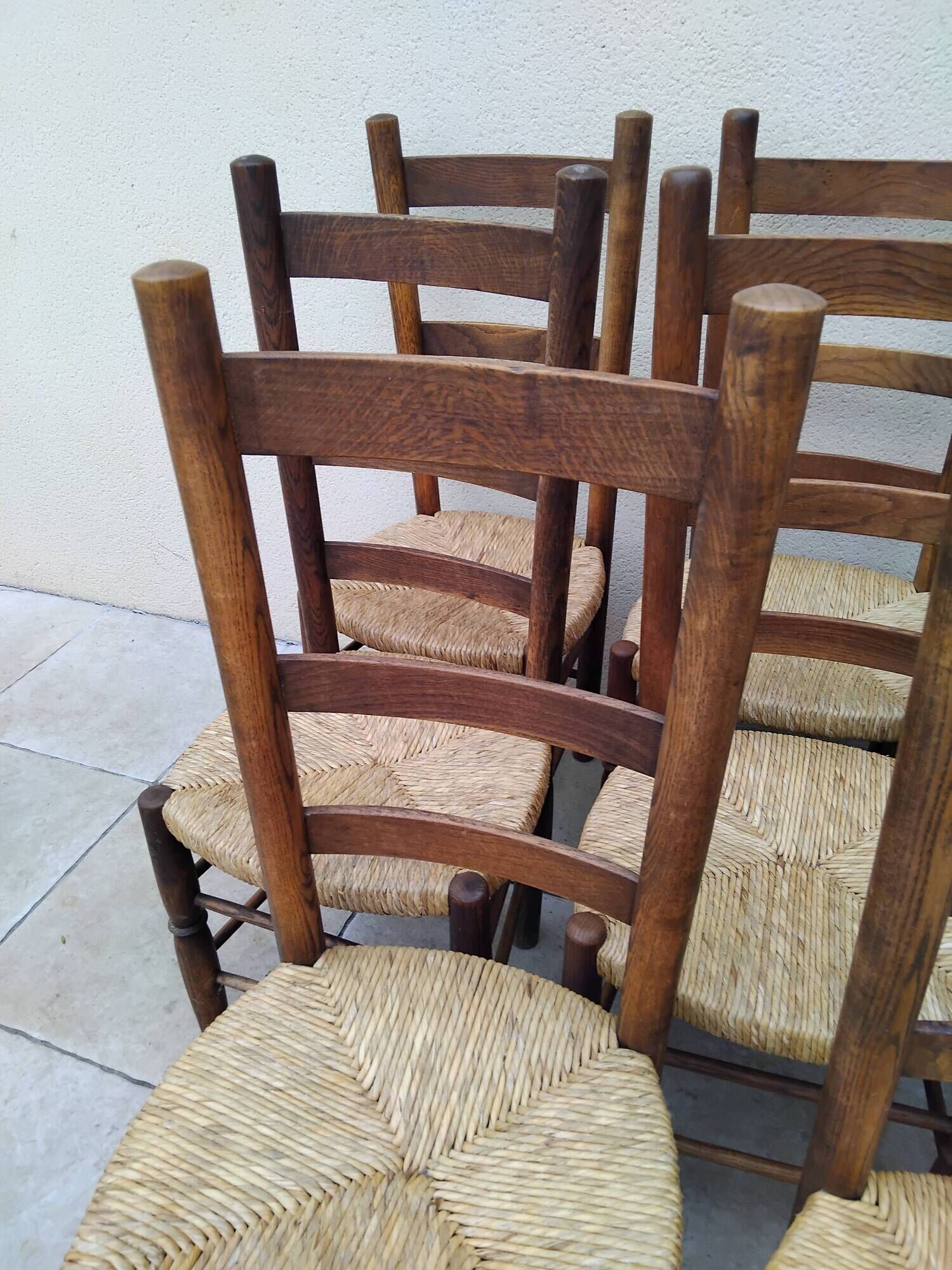 8 vintage straw chairs in the style of Charlotte Perriand.