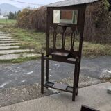 Antique brown wooden coat rack with mirror and umbrella stand, 1900 style.