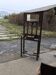 Antique brown wooden coat rack with mirror and umbrella stand, 1900 style.