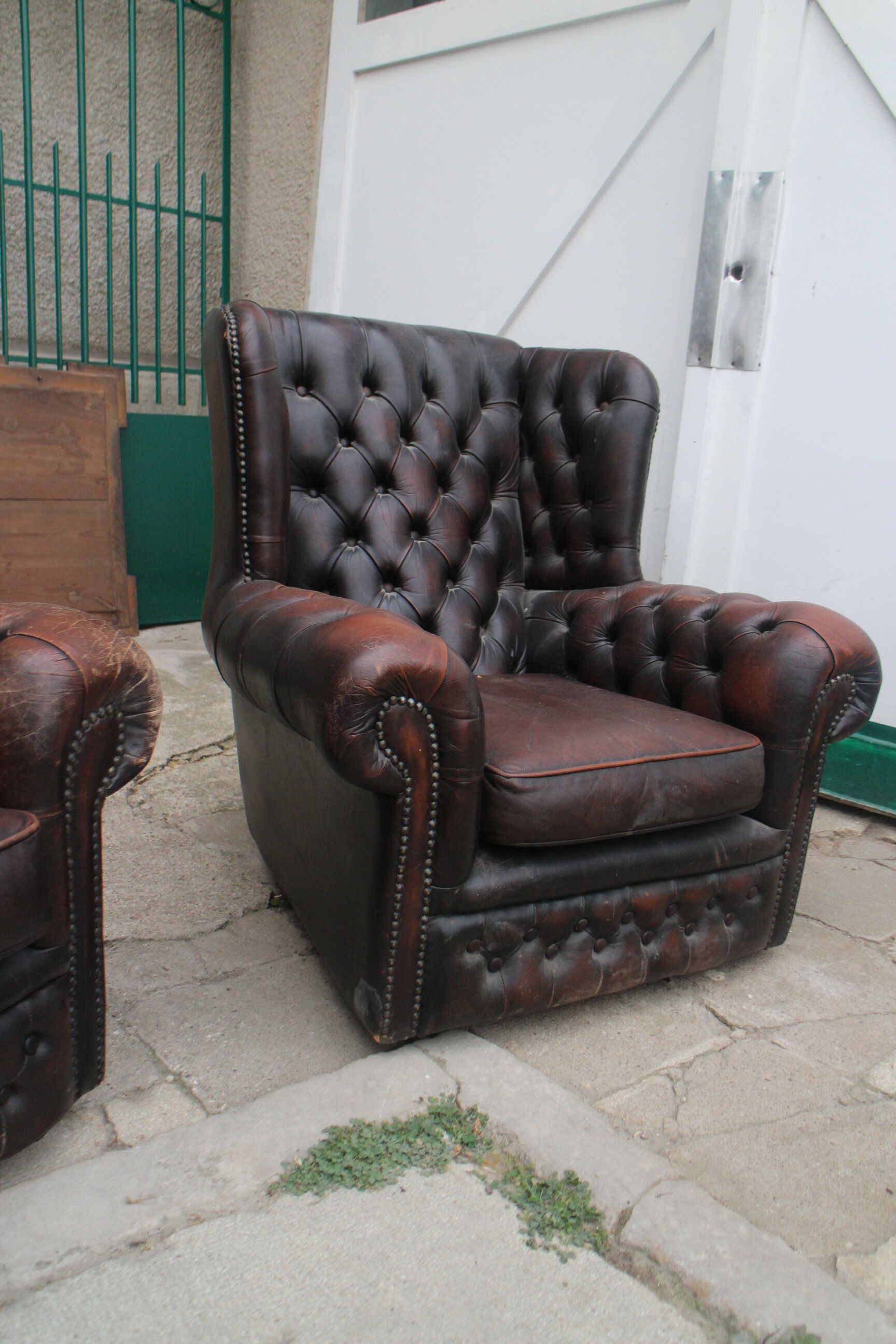 Padded chesterfield leather armchairs