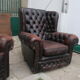 Padded chesterfield leather armchairs