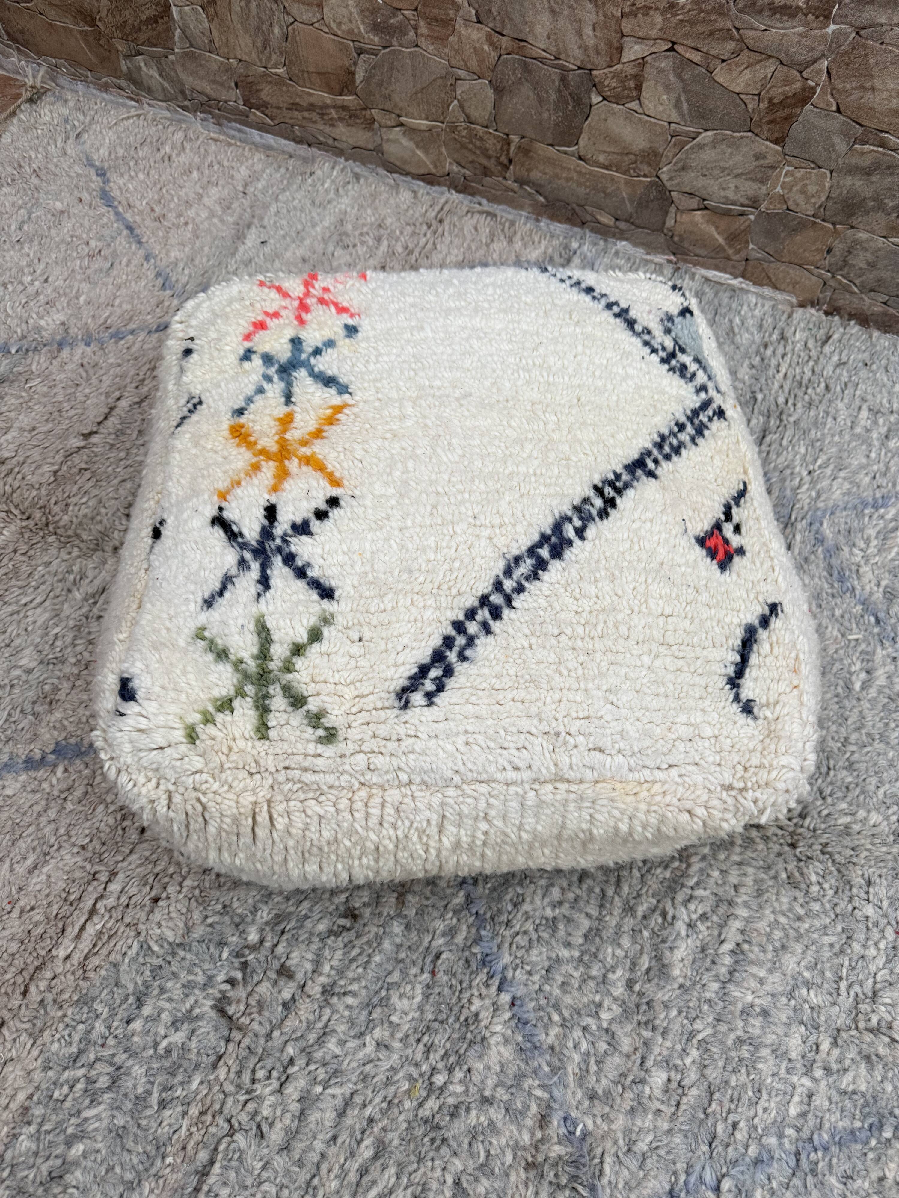 Berber floor pouf: Handwoven Moroccan wool cushion.