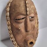 Decorative African mask in carved wood and cowrie shells, Baoulé style, 34 cm
