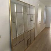 Handcrafted industrial mirror made to measure with a hand-aged frame and brass finish.
