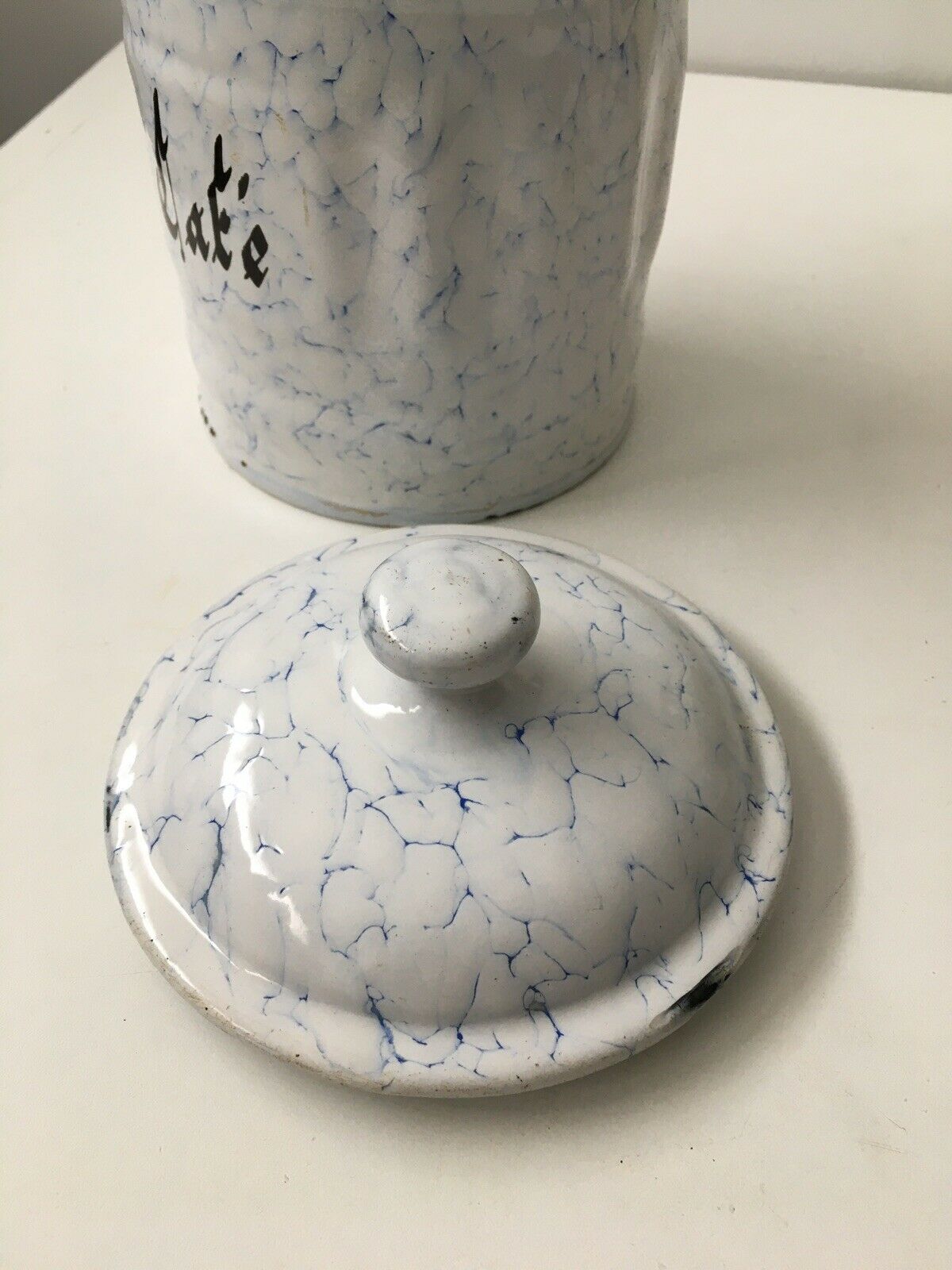 Vintage coffee pot in white enamelled iron and blue retro kitchen decoration