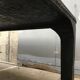 large industrial table in graphite black riveted metal