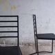 Set of 4 minimalist black steel dining chairs.
