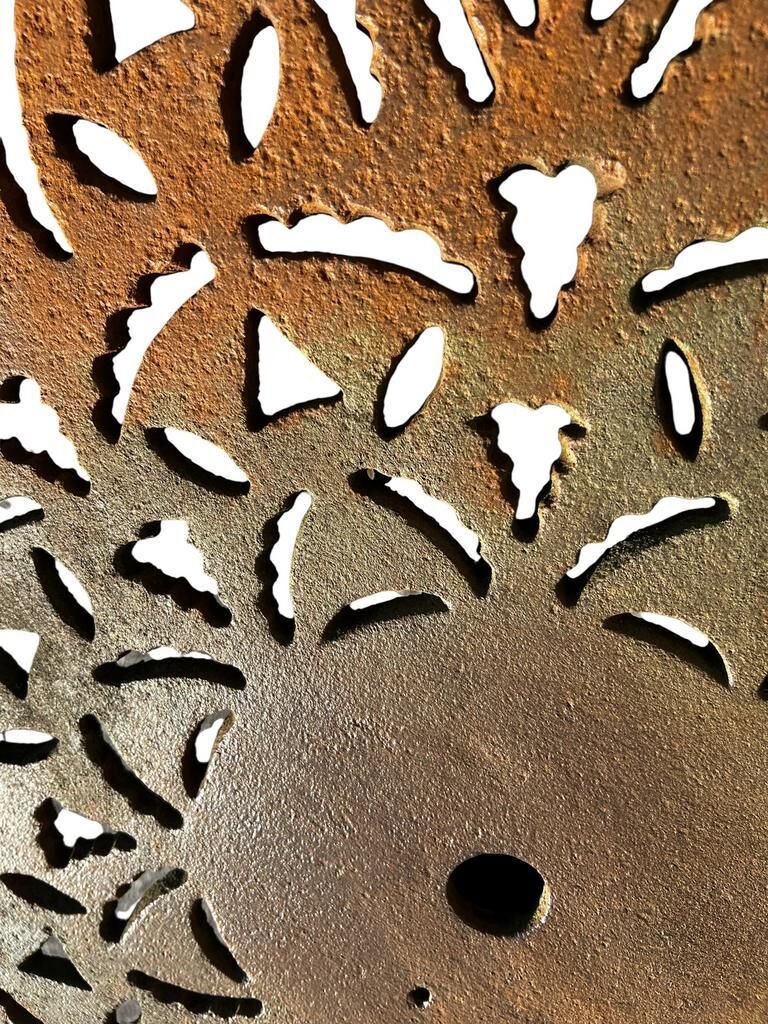 Antique cast iron garden table with decorative openwork top.