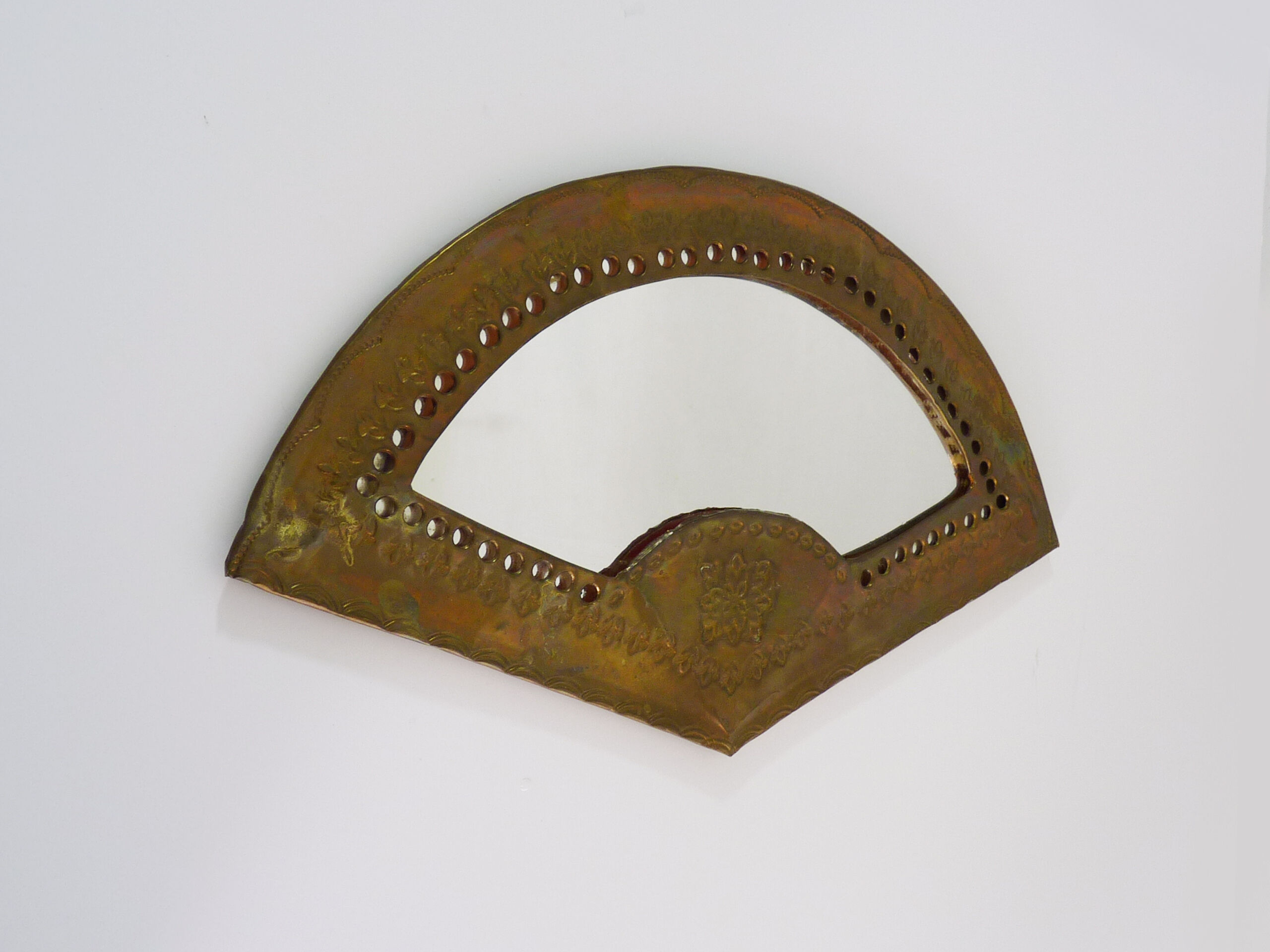 Old wall mirror in the shape of a copper fan pushed back, year 70